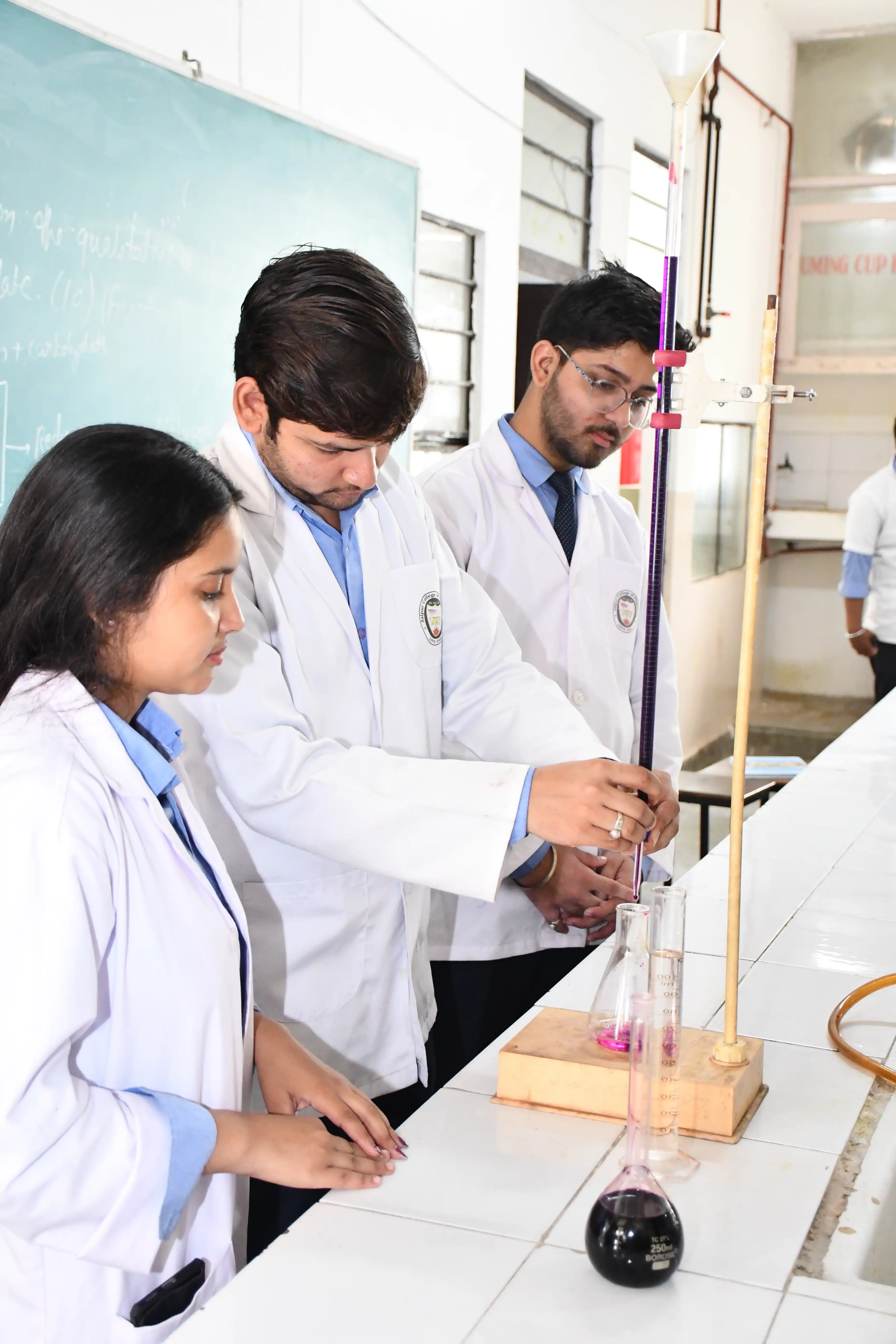 Students performing pharmaceutical chemistry practical work